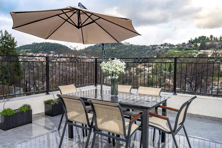 Terrace table under umbrella overlooking Tzfat