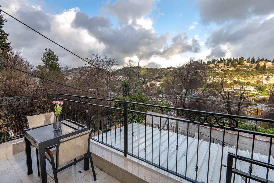 Small balcony table overlooking the hills at dusk