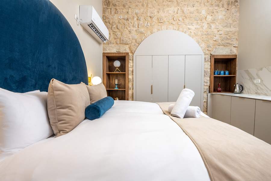 Suite bedroom with blue velvet headboard