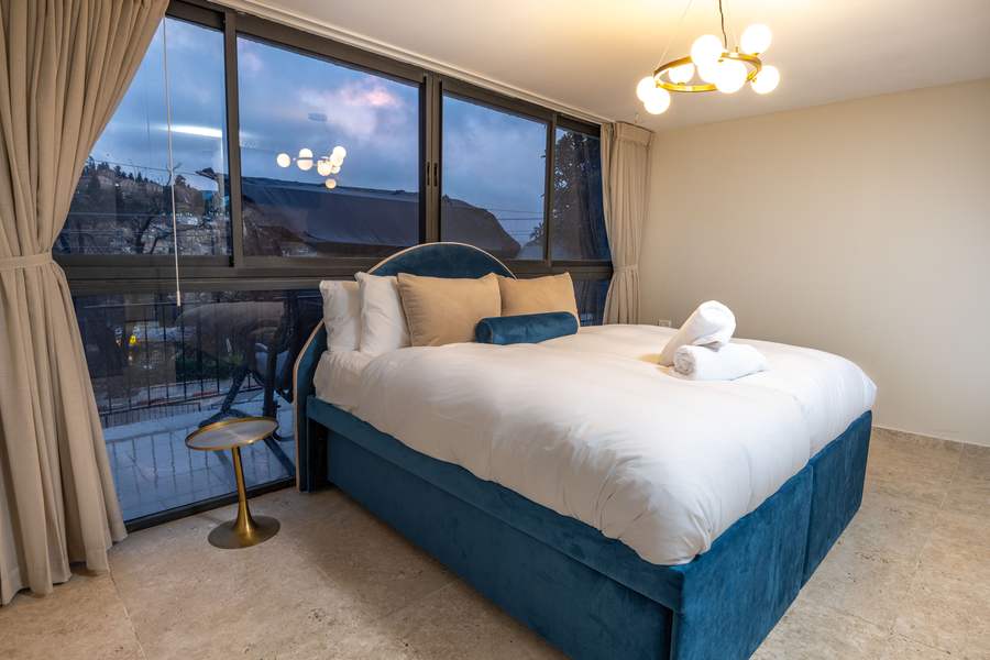 Suite bedroom with balcony and evening view
