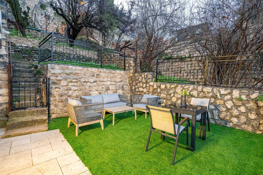 Garden lounge corner among stone walls